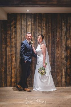 manor house quorn wedding photography bride groom in front of wooden rustic boards wall